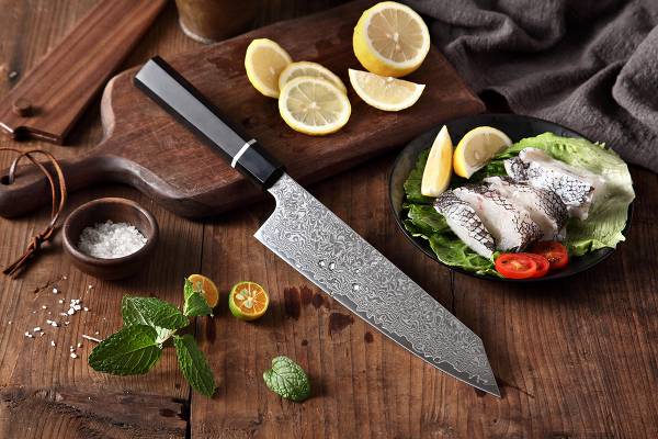 Šéfkuchařský nůž XinZuo Bunka na prkénku položený